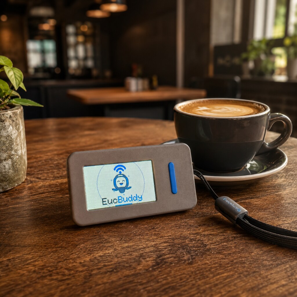 EucBuddy device next to a coffee cup in a cafe